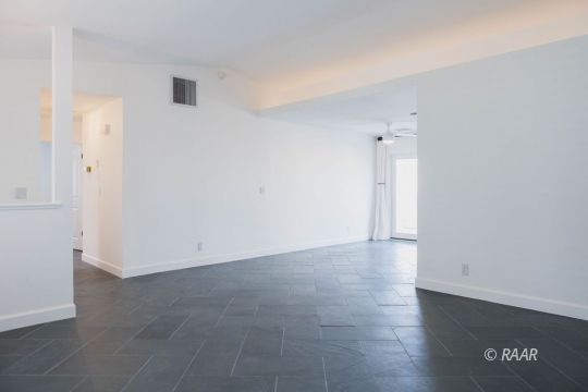 432 Ashton Street Ridgecrest, CA 93555 - Photo 8 of 31 an empty room with wooden floor and windows