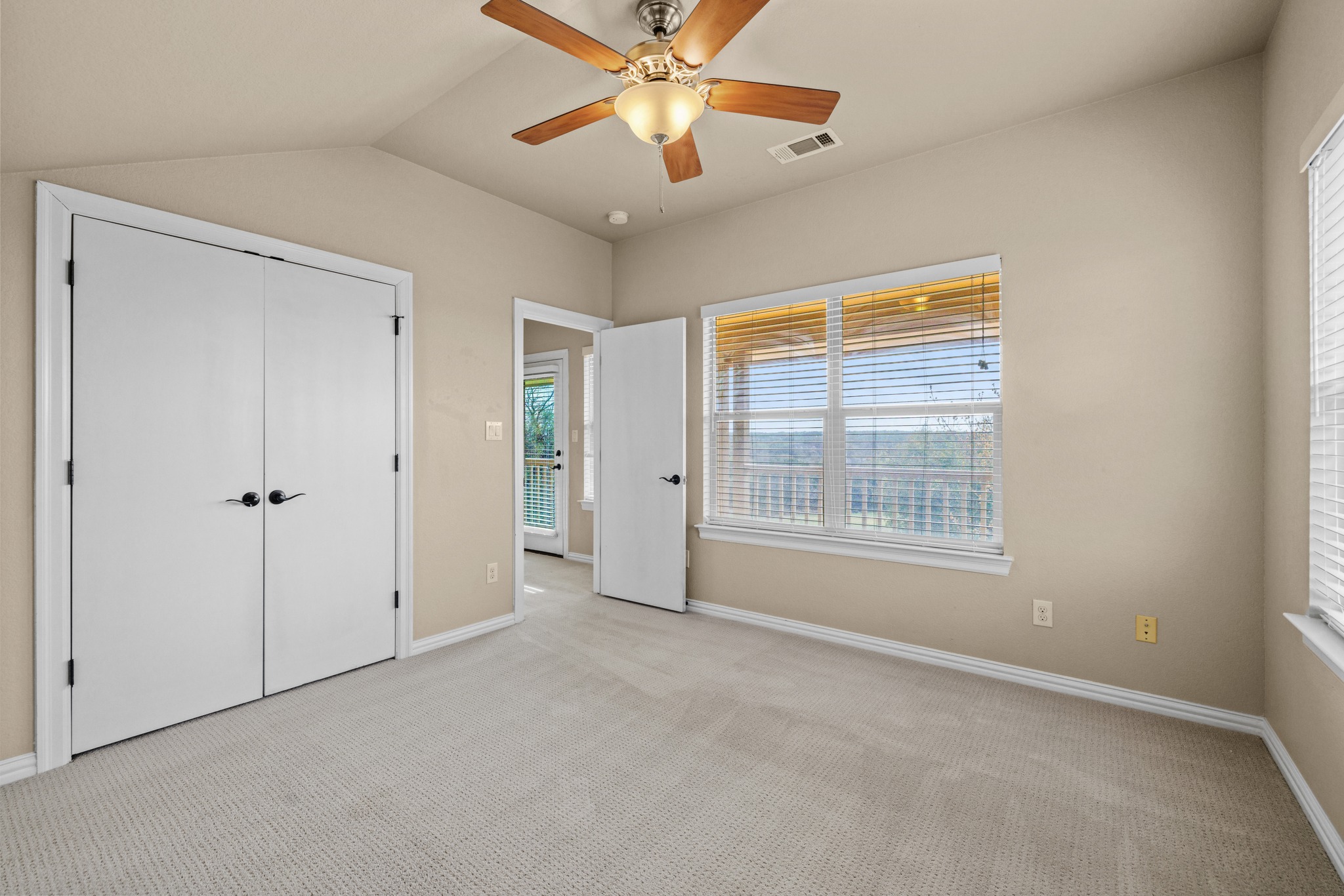 204 Skyline Road Georgetown, TX 78628 - Photo 28 of 40 Unfurnished bedroom with light carpet, ceiling fan, a closet, and vaulted ceiling
