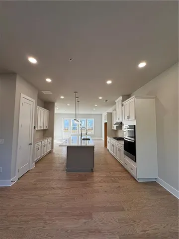 a kitchen with stainless steel appliances a refrigerator sink and microwave