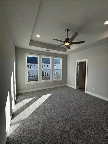 a view of a livingroom with a ceiling fan and window