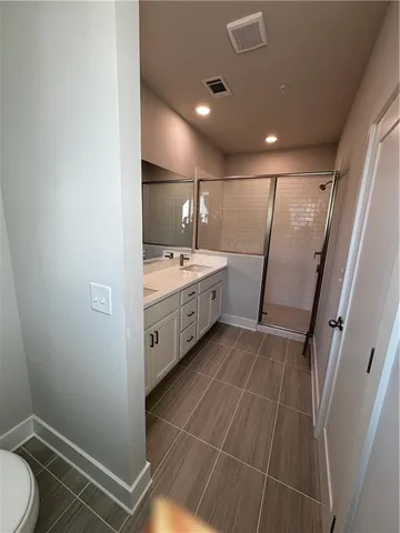 a bathroom with a double vanity sink and a mirror