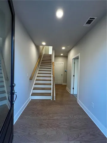 a view of entryway and hall with wooden floor