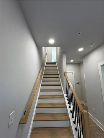 a view of entryway and hall with wooden floor