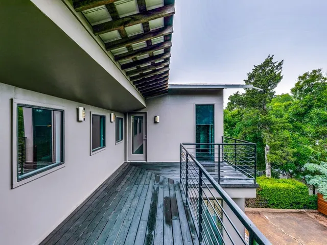 a view of a roof deck with wooden floor and fence
