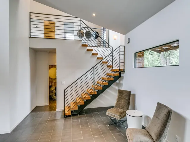 a bathroom with a toilet and a hallway