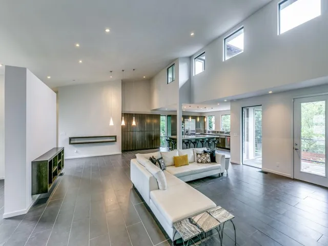 a living room with fireplace furniture and a wooden floor