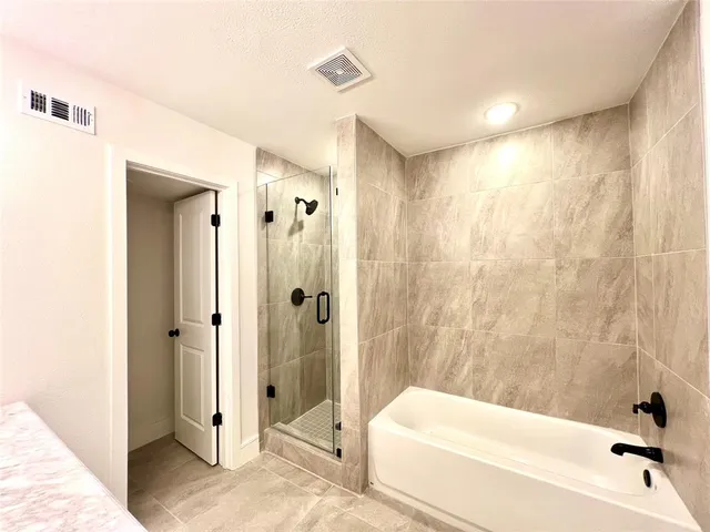 a bathroom with a tub and shower