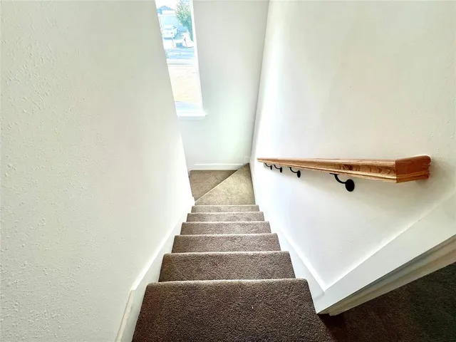 a view of a hallway with staircase