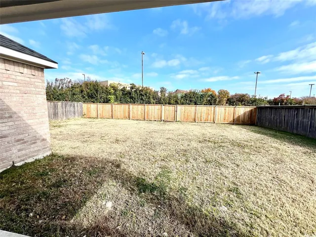 a swimming pool with outdoor seating and yard