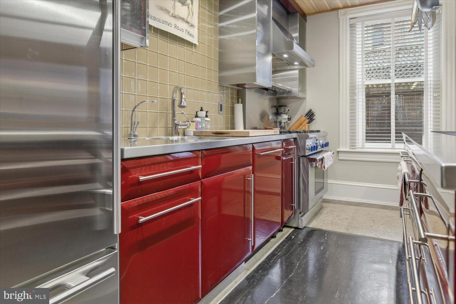 116 11th Street Northeast Washington, DC 20002 - Photo 17 of 40 Sleek kitchen with vibrant red accents.