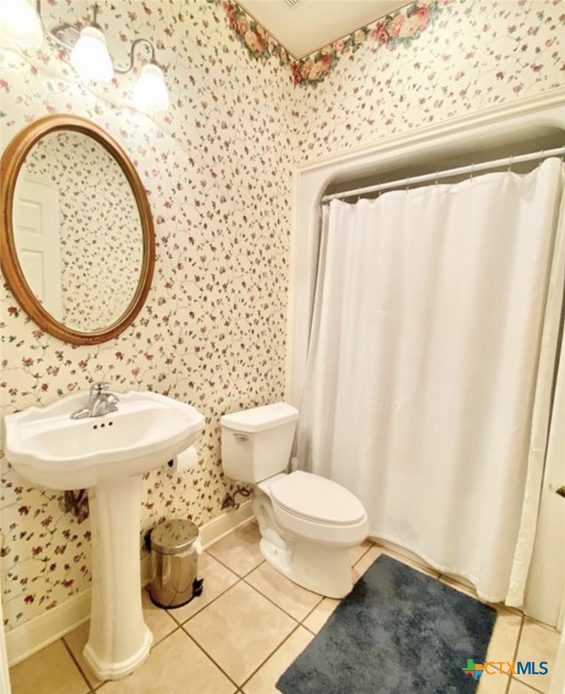 415 South Trinity Street Edna, TX 77957 - Photo 33 of 46 a bathroom with a sink and a mirror