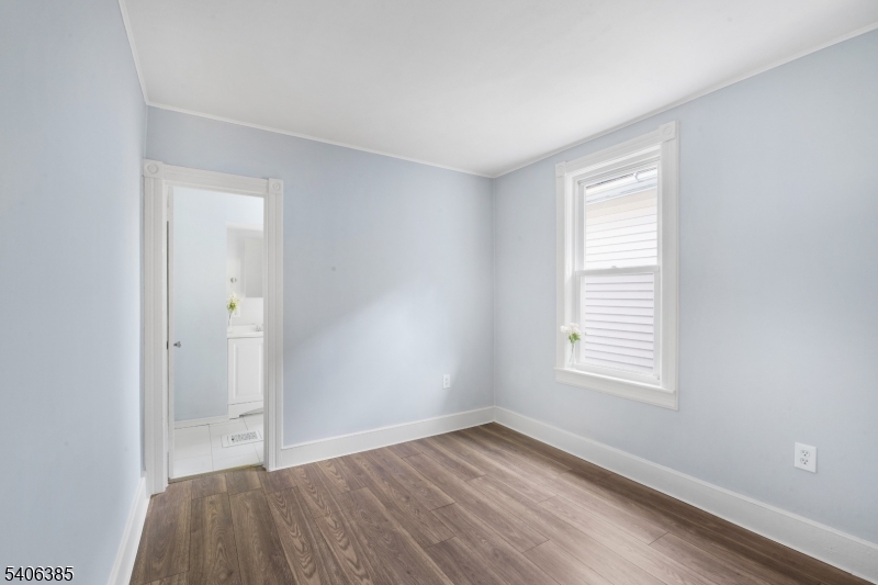 313 Mercer Street Phillipsburg, NJ 08865 - Photo 11 of 29 an empty room with wooden floor and windows