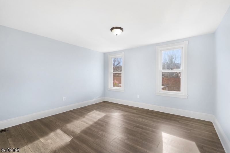 313 Mercer Street Phillipsburg, NJ 08865 - Photo 15 of 29 a view of an empty room with wooden floor and a window