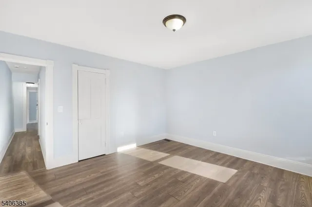 a view of a room with wooden floor