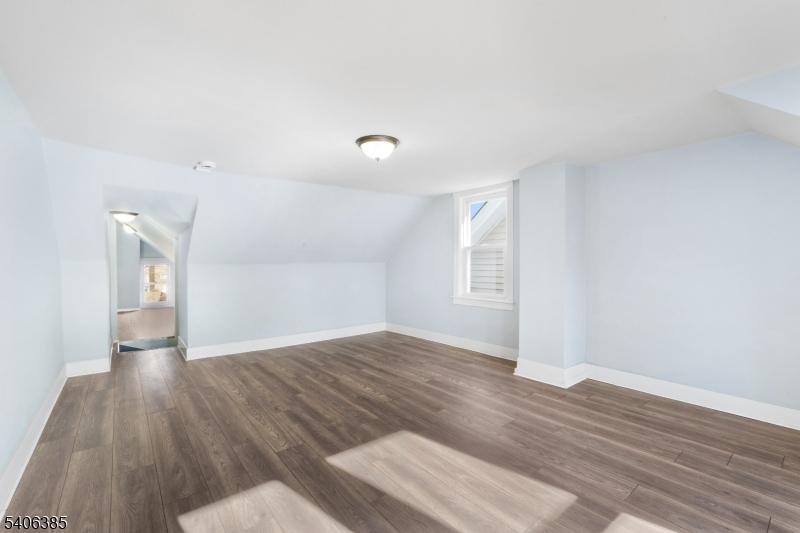 313 Mercer Street Phillipsburg, NJ 08865 - Photo 18 of 29 a view of an empty room with wooden floor and a window