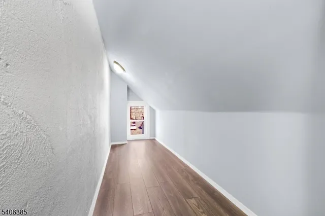 a view of an empty room and wooden floor