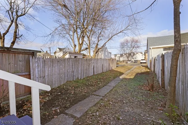 a view of a backyard with wooden fence