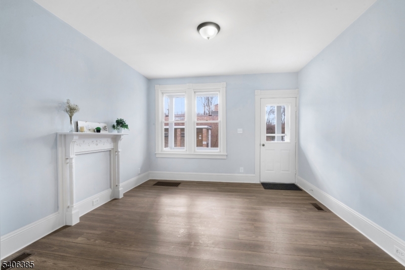 313 Mercer Street Phillipsburg, NJ 08865 - Photo 4 of 29 an empty room with wooden floor and windows