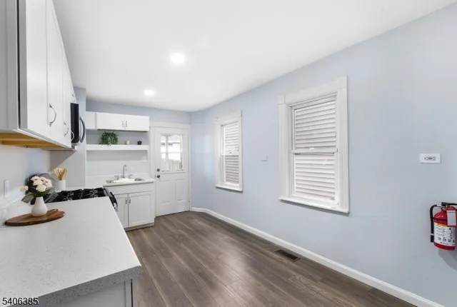 a kitchen with stainless steel appliances granite countertop a sink stove and wooden floor