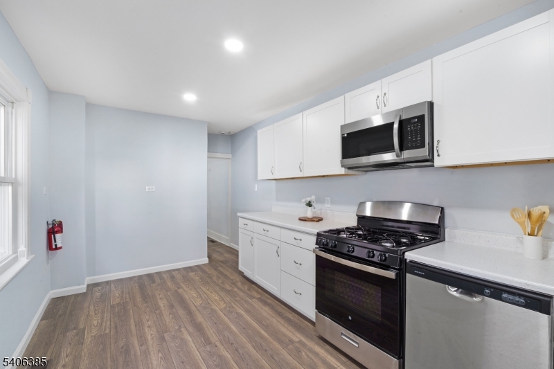 313 Mercer Street Phillipsburg, NJ 08865 - Photo 10 of 29 a kitchen with stainless steel appliances kitchen island granite countertop a stove a sink and a microwave