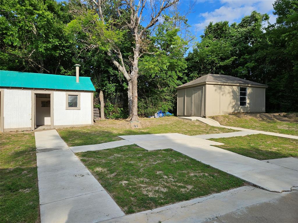 234 East Fork Road Sunnyvale, TX 75182 - Photo 16 of 32 a view of a house with a yard and large tree