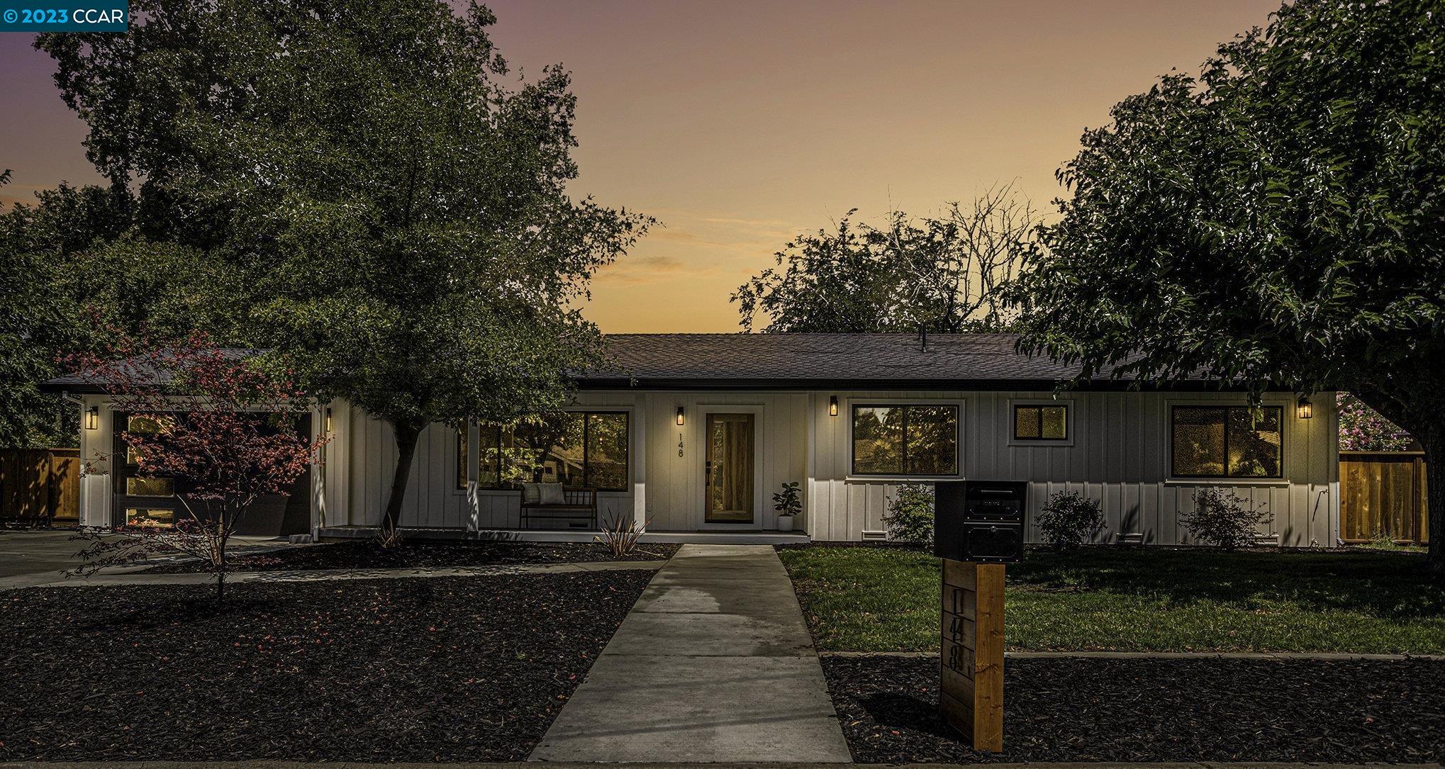 148 Arbolado Drive Walnut Creek, CA 94598 - Photo 1 of 1 a front view of a house with a yard and potted plants