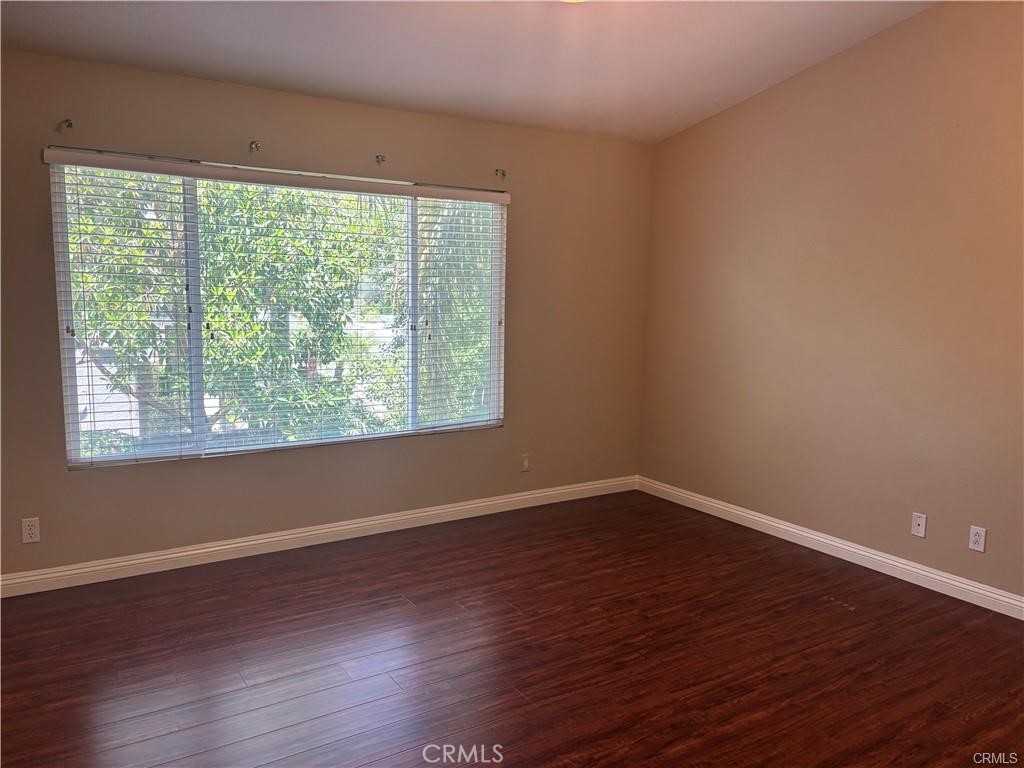 20 Berlamo Rancho Santa Margarita, CA 92688 - Photo 16 of 34 a view of an empty room with wooden floor and a window