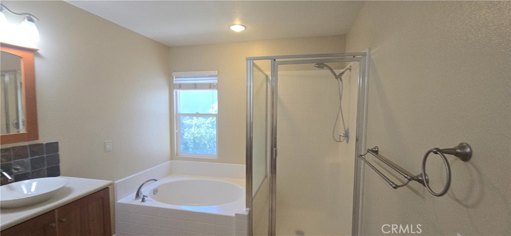 20 Berlamo Rancho Santa Margarita, CA 92688 - Photo 20 of 34 a bathroom with a granite countertop sink a mirror and a bathtub