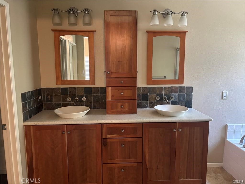 20 Berlamo Rancho Santa Margarita, CA 92688 - Photo 21 of 34 a bathroom with a granite countertop sink and a mirror