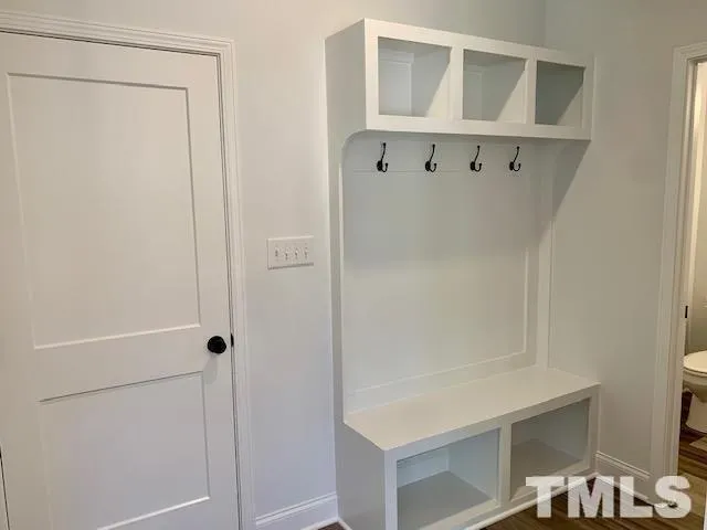 a view of a hallway with wooden floor and entryway