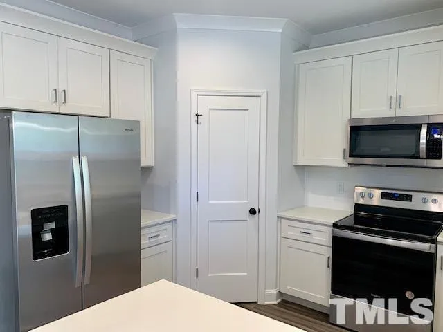 a kitchen with stainless steel appliances wooden cabinets and stove
