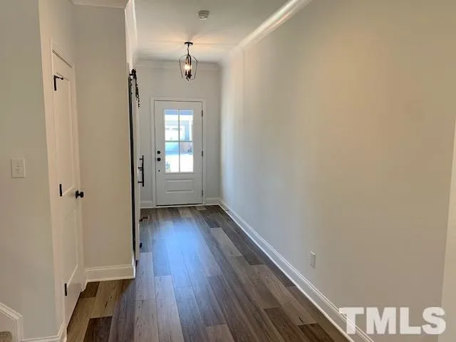 a view of a room with wooden floor and window