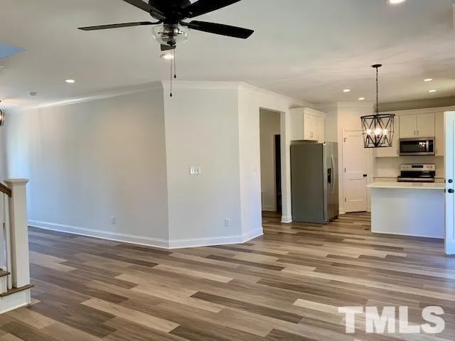 a view of a kitchen with refrigerator and a ceiling fan
