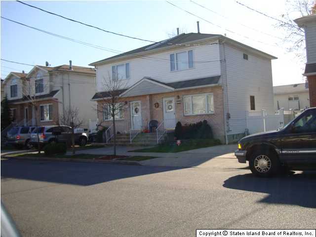 a car parked in front of a white house