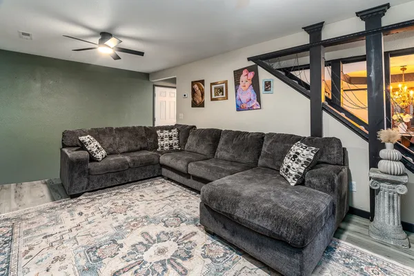 a living room with furniture and a ceiling fan
