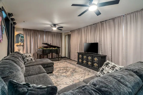 a living room with furniture and a flat screen tv