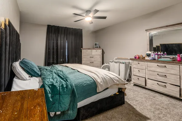a bedroom with a bed and a dresser in it