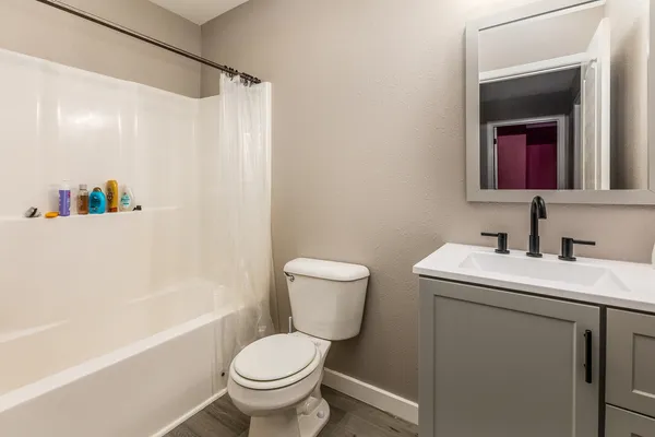 a bathroom with a sink toilet and shower