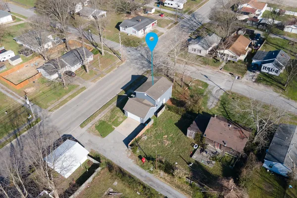 an aerial view of a house with a yard