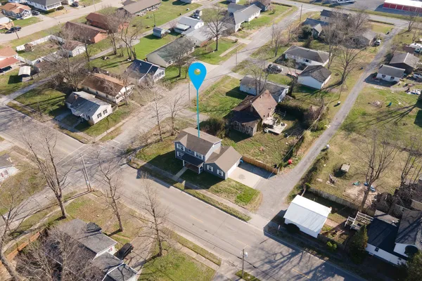 an aerial view of a house with a yard