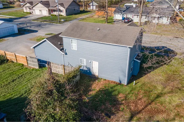 a aerial view of a house with a yard