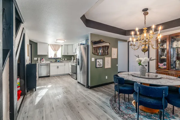 a kitchen with kitchen island granite countertop a sink cabinets and stainless steel appliances