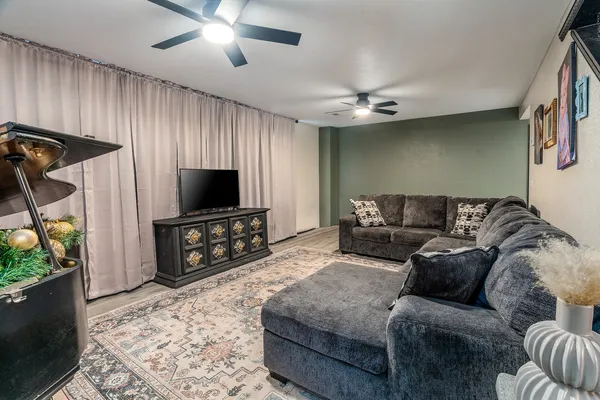 a living room with furniture and a flat screen tv