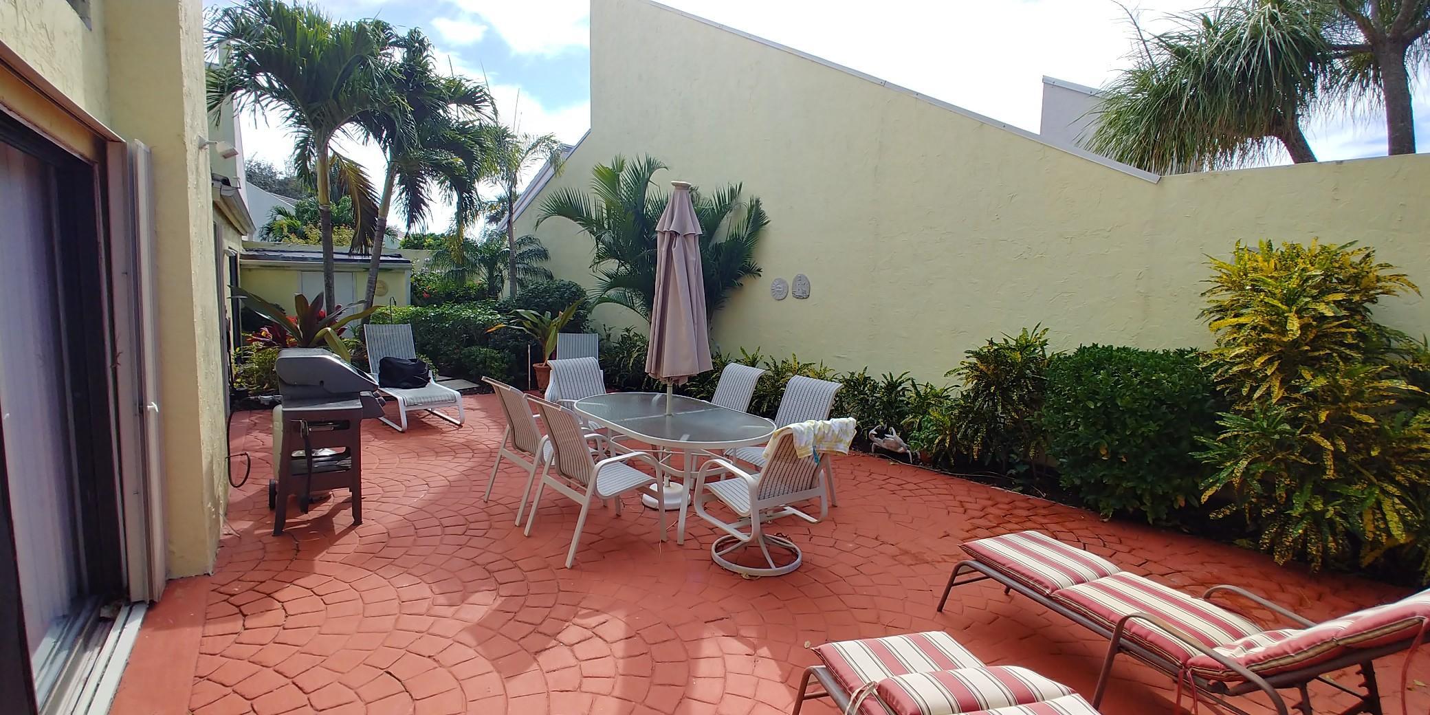 17042 Traverse Circle Jupiter, FL 33477 - Photo 9 of 30 a view of a backyard with sitting area