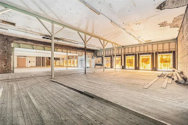 a bathroom with a sink and wooden floor