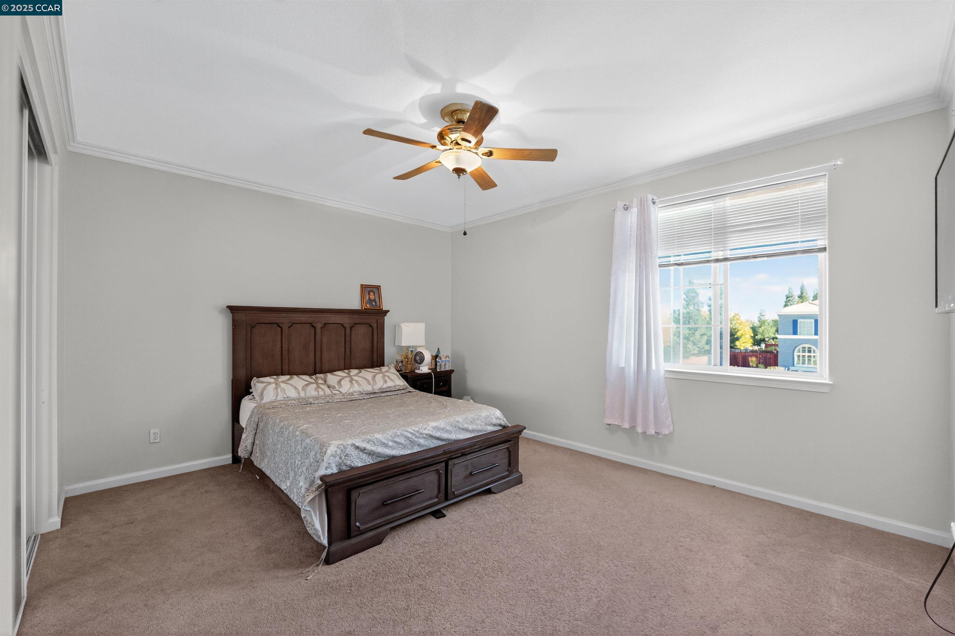 4100 Diorite Court Antioch, CA 94531 - Photo 19 of 35 a bedroom with a bed and a chandelier