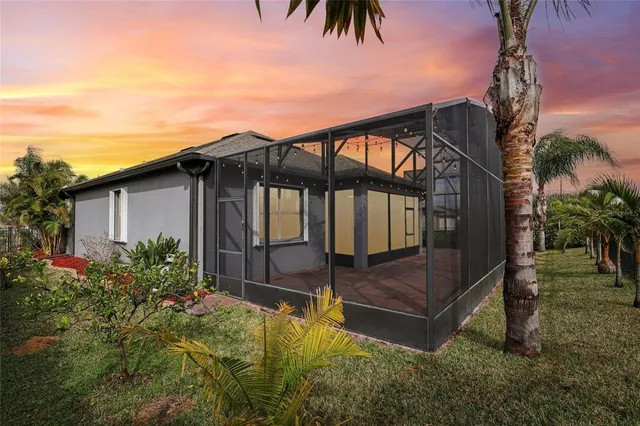 a backyard of a house with table and chairs