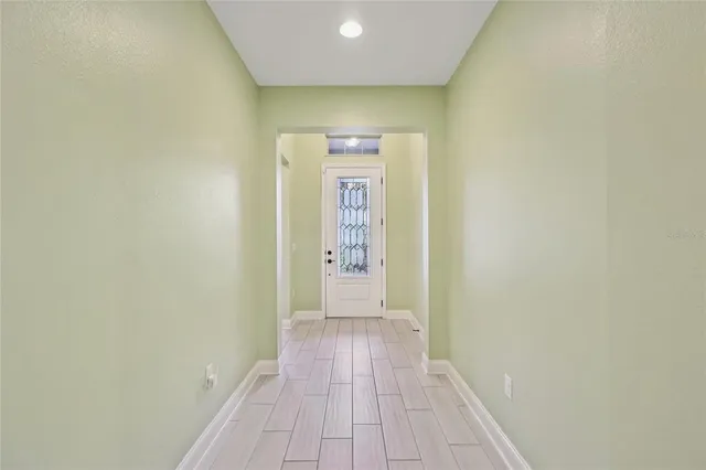 a living room with furniture kitchen view and a large window