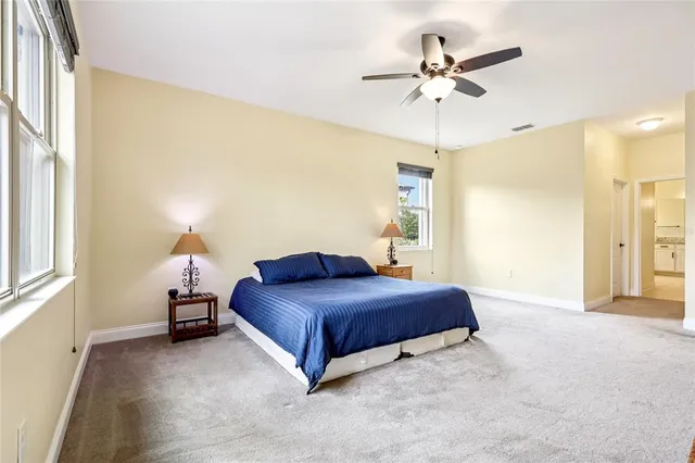 a spacious bathroom with a double vanity sink a mirror and a bathtub