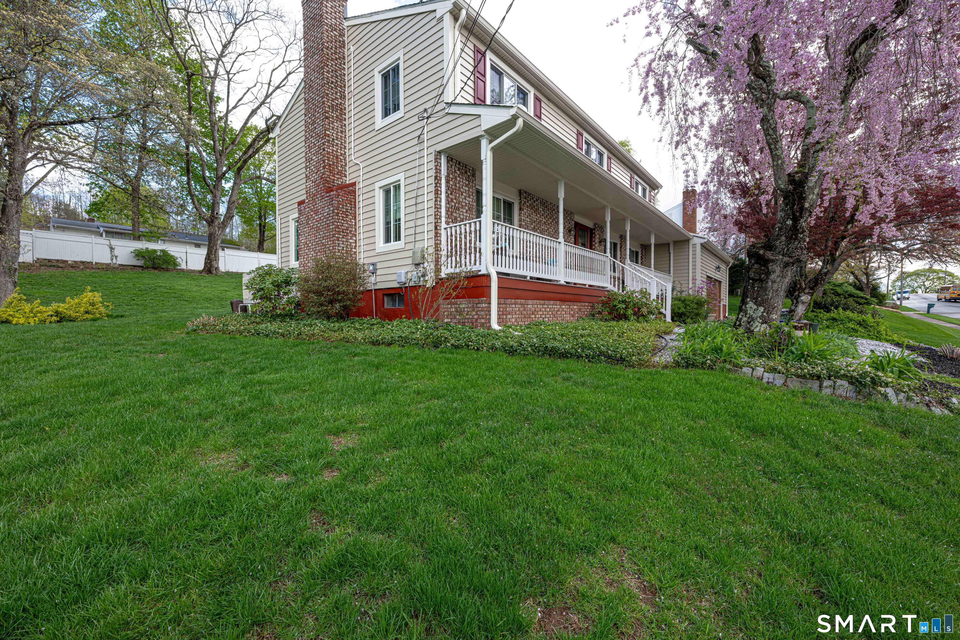a front view of house with yard and green space